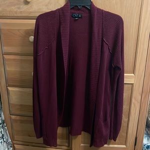 Burgundy open sweater.
